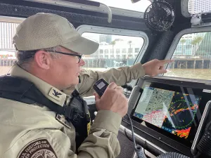 Supervisory Marine Interdiction Agent Mark Spruill patrols on a CBP Air and Marine Operations boat along the waterfront of downtown New Orleans