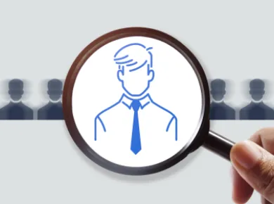 Image, magnifying glass on a silhouette of a person from a line of silhouettes of people. Link, Contact Us