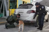 A Border Patrol agent and a CBP officer train a CBP canine to detect contraband in or around a vehicle